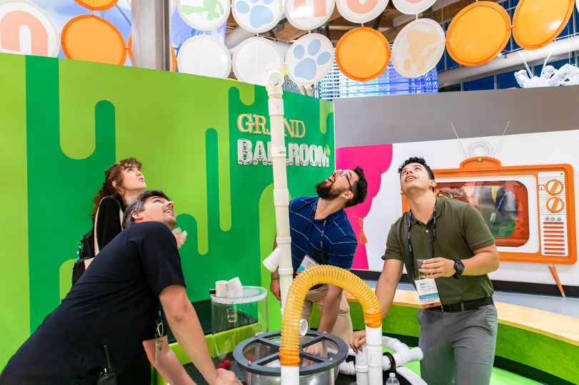 A promotional photo of adults enjoying The Scott Family Amazeum in Bentonville, Arkansas.