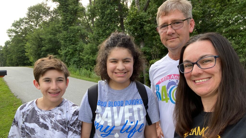 The Maddy family poses for a photo. Kenzie's shirt says "CBCO Blood Donors Saved My Life."