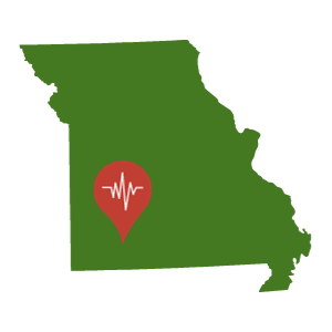 A green outline of the state of Missouri with a red location pin at Monett's location.